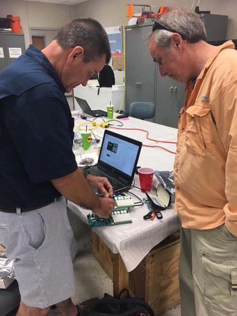 Teacher Robbie Albertson and STTI Lead Learner Bill Vivian use LabVIEW to monitor an experiment.