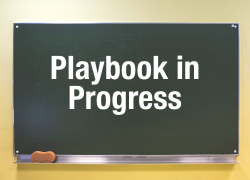 playbook in progress text on a chalkboard background