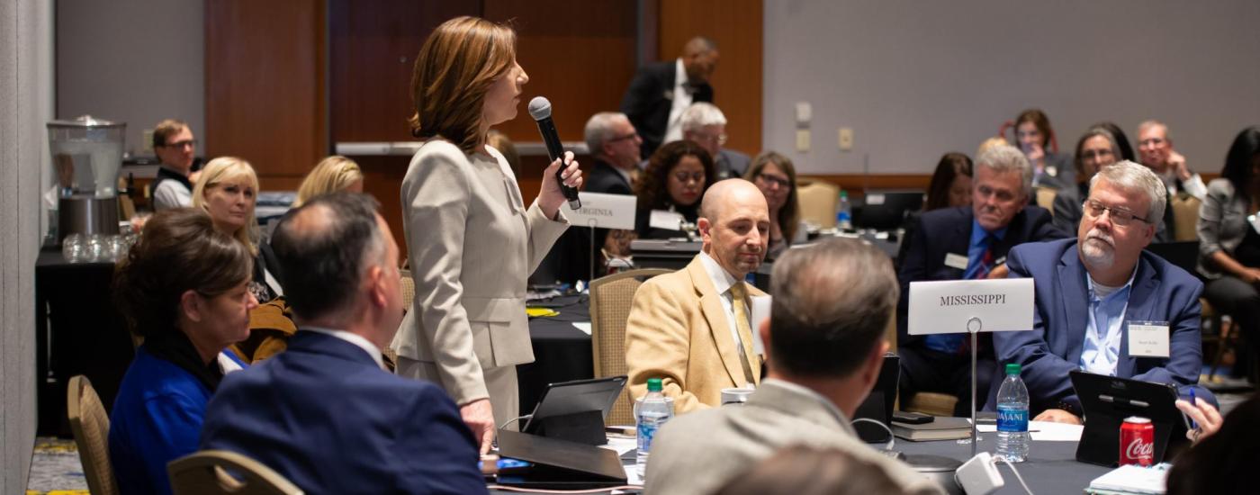 state education leaders seated at a round table at an event