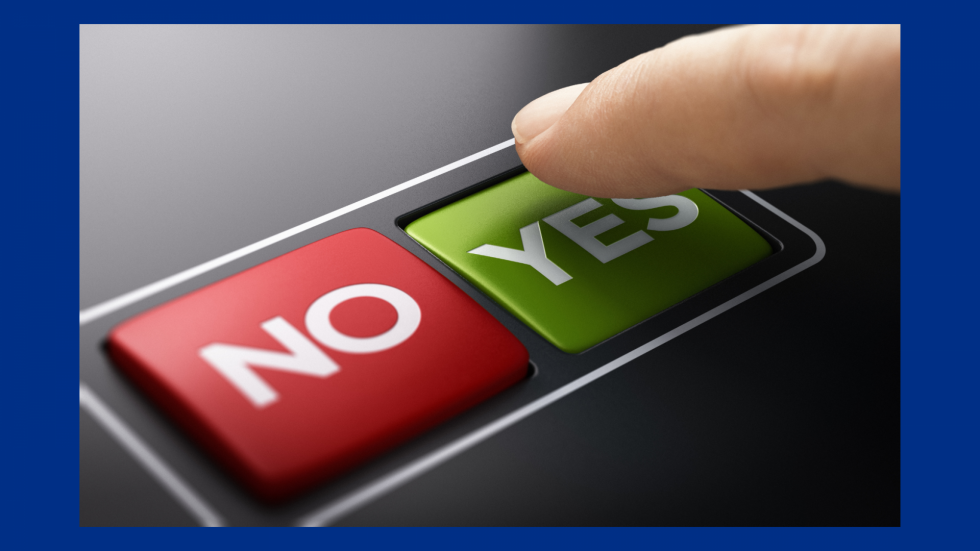 A finger hovering over two buttons, one says yes and the other no