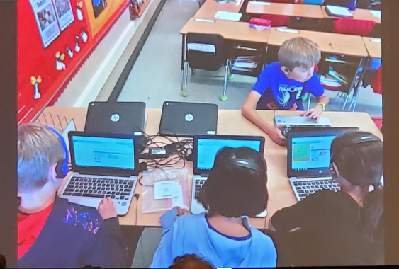 Picture of a class of kids learning to code.