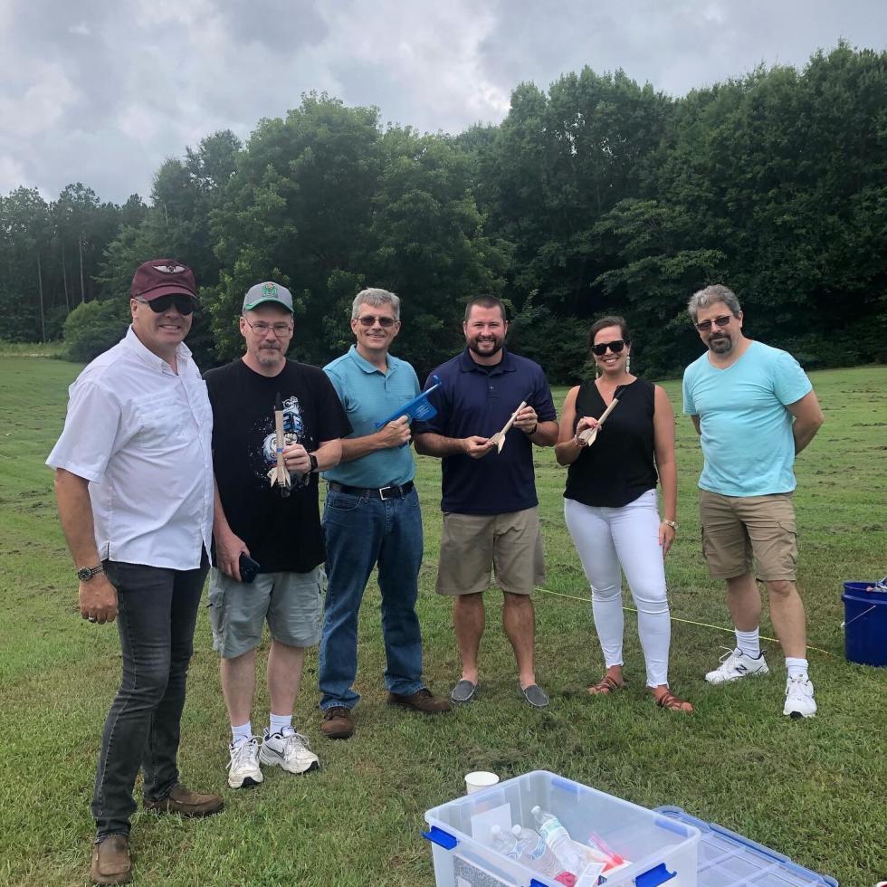 Course 1 teachers test-launch their rocket designs.