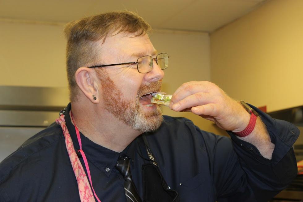 Chef Liljon McCormick taste tests a recipe that will be used in the cookbook.