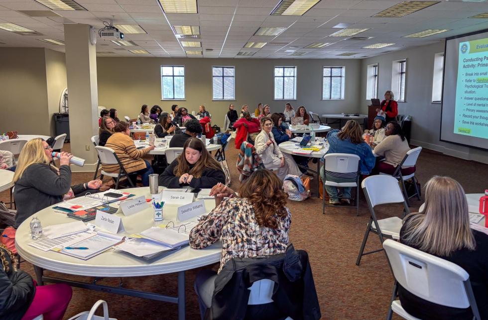 Counselors listen to a presentation on crisis response