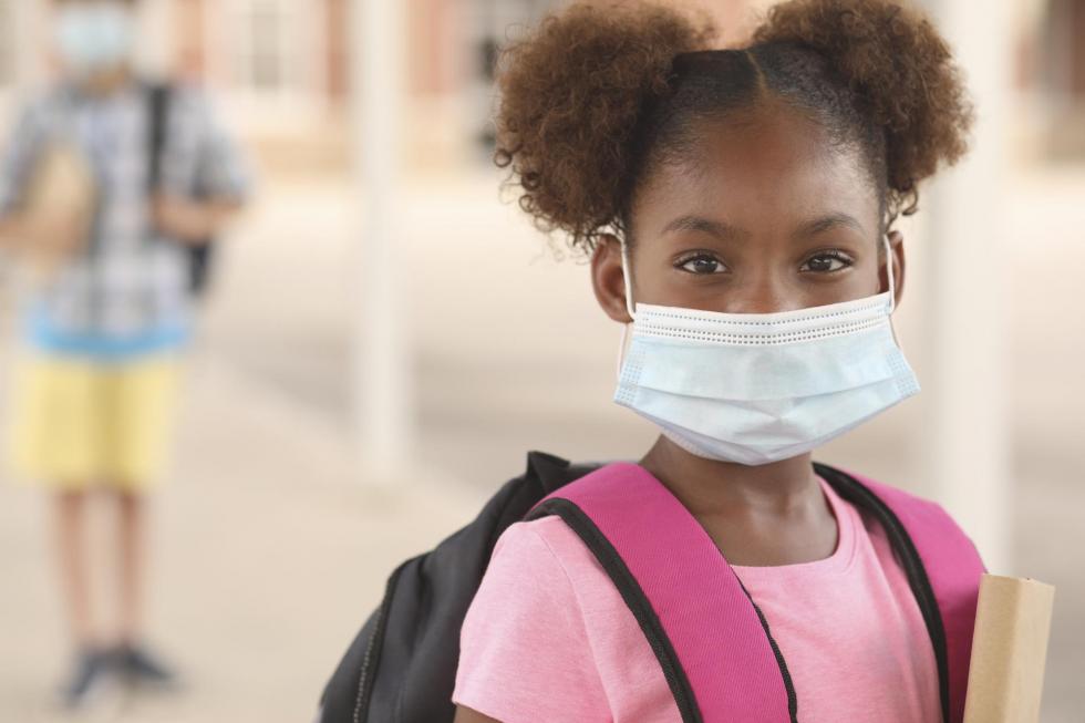 elementary aged girl wearing a protective mask