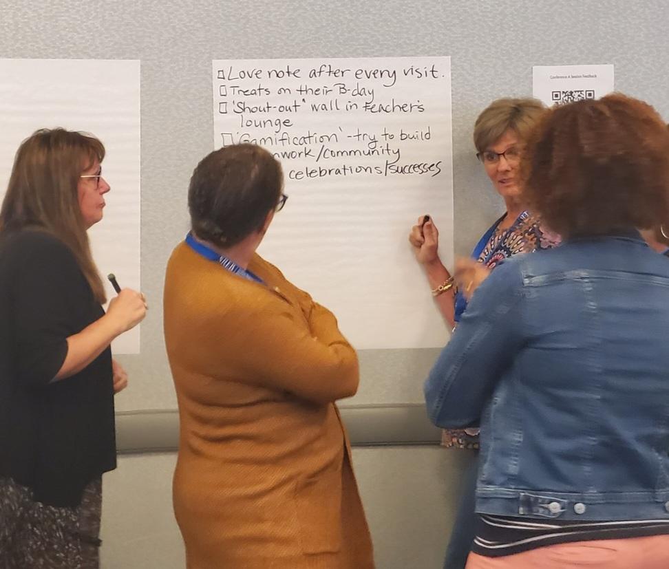 A group of participants write down the ways they encourage teachers