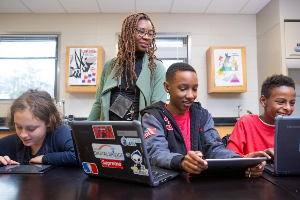 Teacher and middle school students in classroom