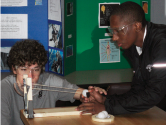 Aeronautics engineering students test launch and range angles on their ballistics apparatus.
