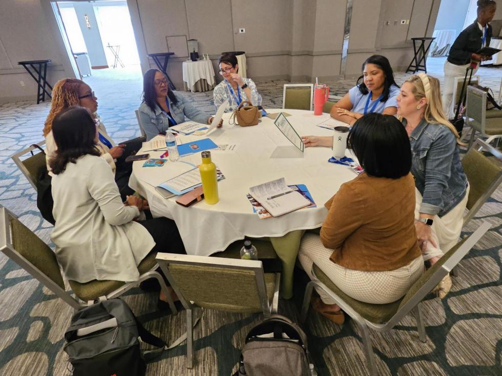 Attendees discuss their holdbacks