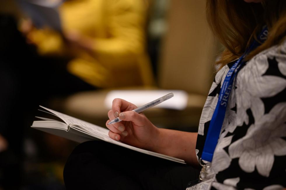 An attendee taking notes during the session.
