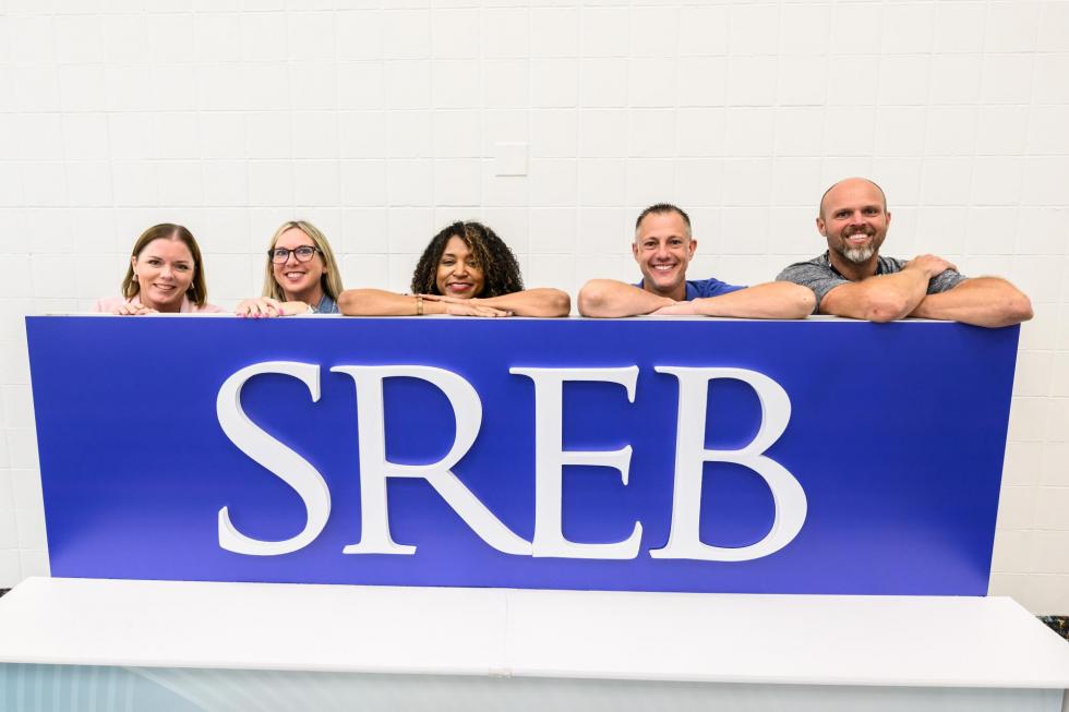 2025 attendees pose at the SREB sign