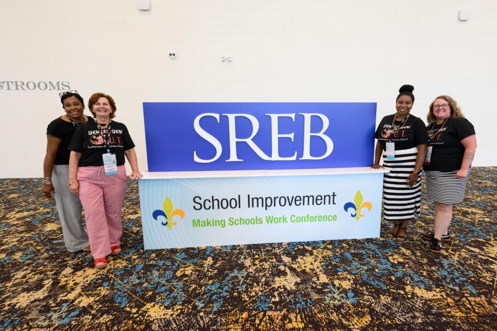 2025 attendees pose in front of an SREB sigh
