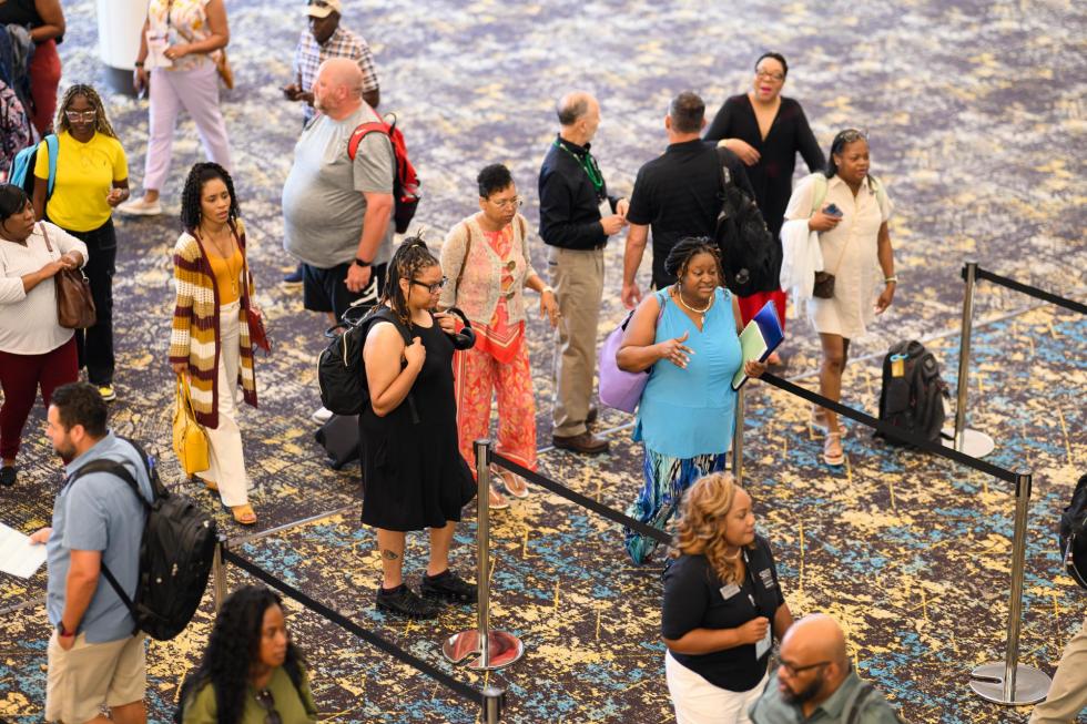 Attendees go to register at the 2025 conference