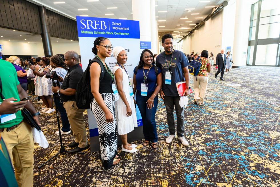 2025 attendees stand in front of an SREB sign