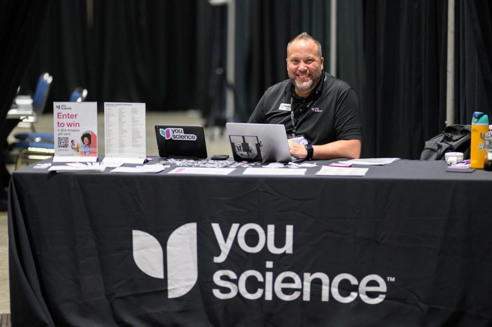 YouScience sets up their exhibitor booth at the 2025 conference