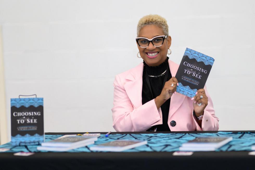 An author sets up her book signing table at the 2025 conference