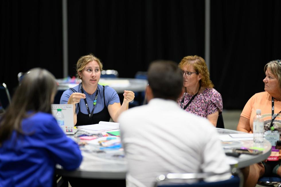 Attendees at the 2025 conference have a discussion during a session