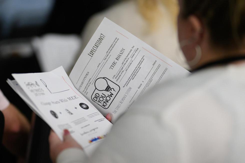 An attendee looks at worksheets Shree Walker handed out during her session.