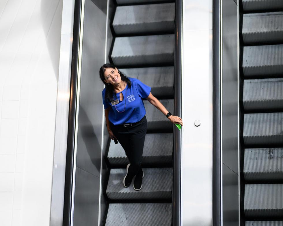 Aimee Wyatt riding the escalator at the 2025 conference
