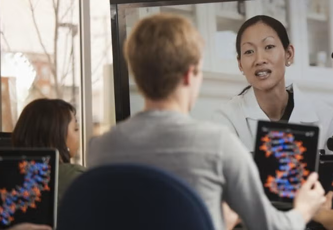 student with remote teacher on screen
