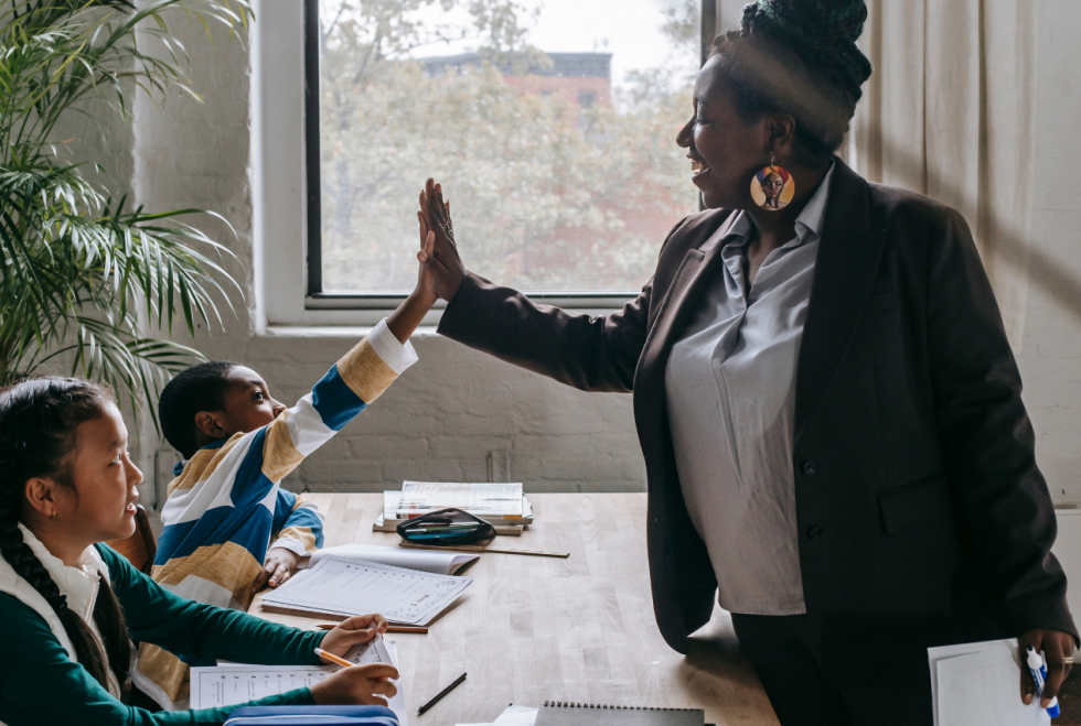 teacher high-fiving student