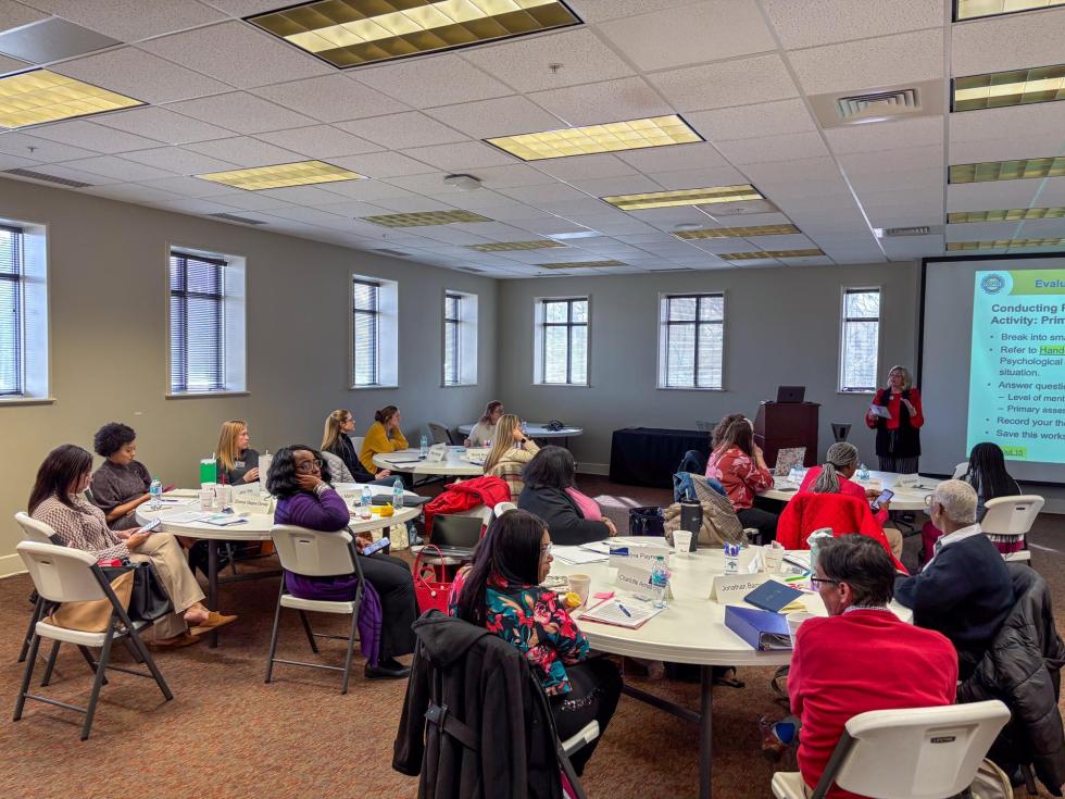 Counselors listen to a presentation on crisis response