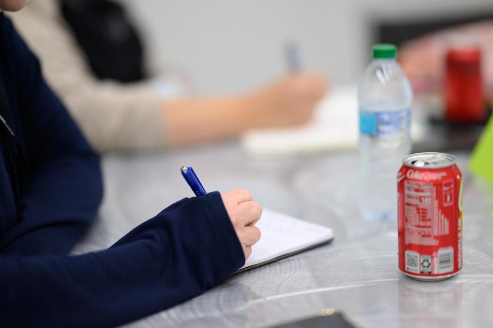2025 attendees take notes at the conference