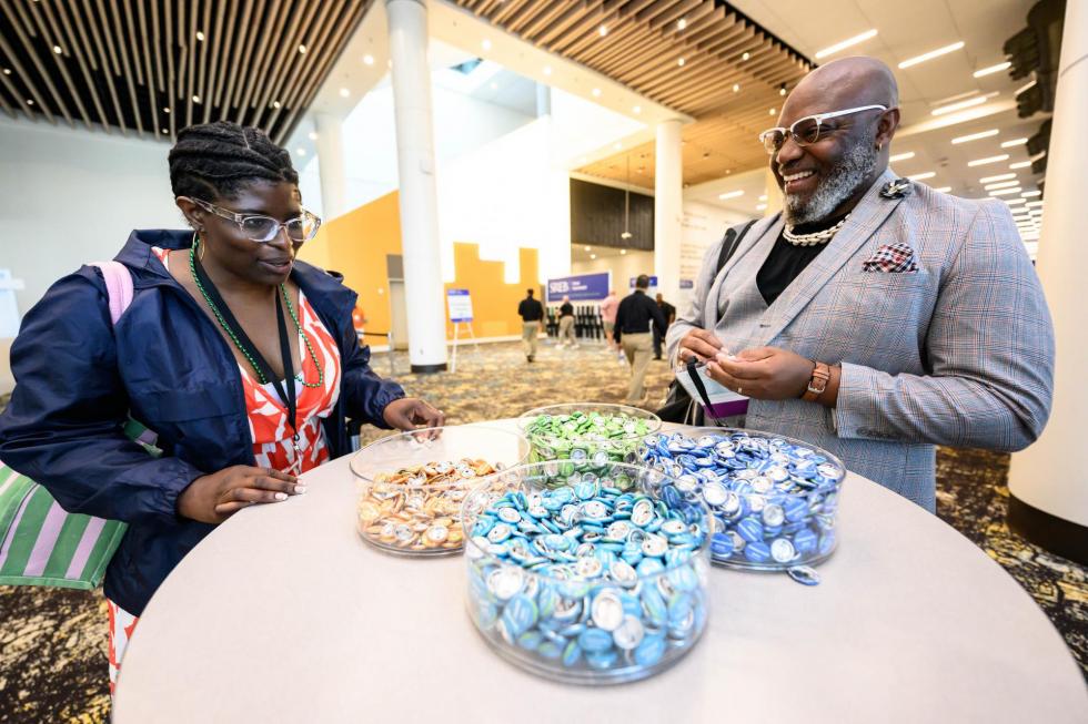 2025 conference attendees pick out buttons