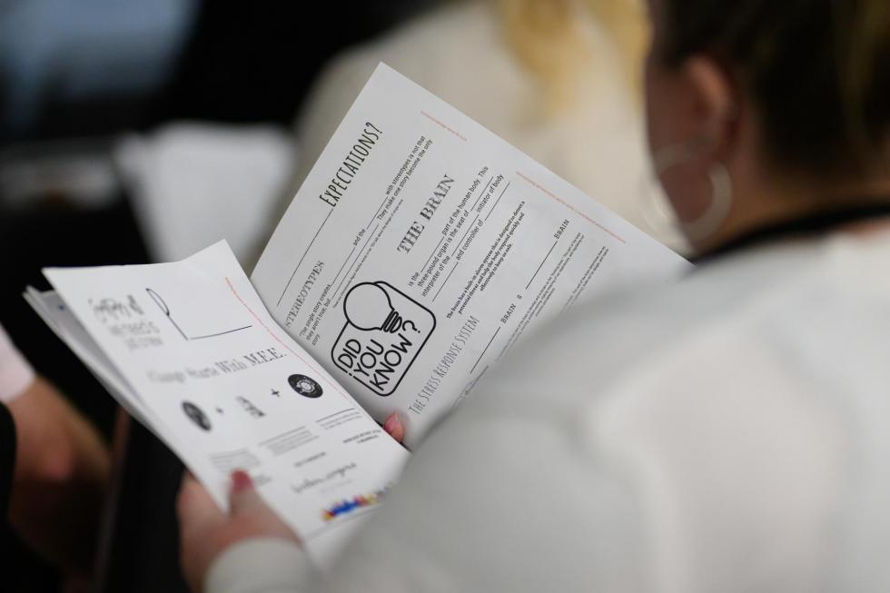 2025 attendee looks at session handouts