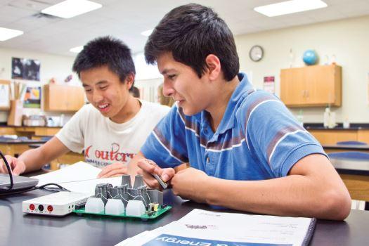 Two male students work on a STEM project.