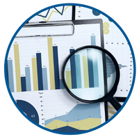 A photo of assorted graphs/charts and a magnifying glass